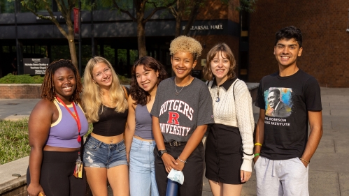 Six new students standing outdoors.