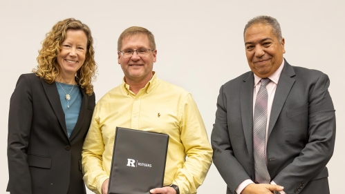 Faculty and staff posing with an award.