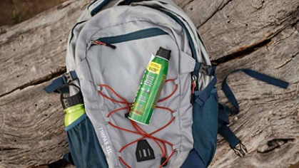 A can of bug spray on a backpack.