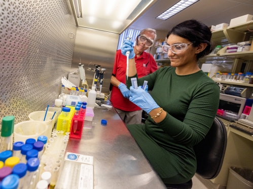 A student in a lab being supervised.