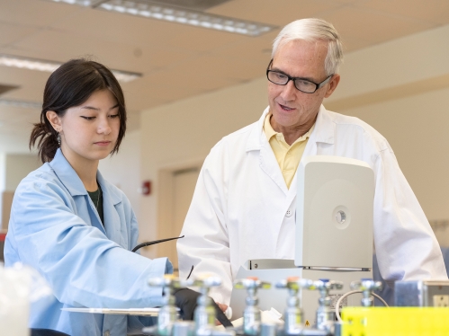A student and a professor in a lab.