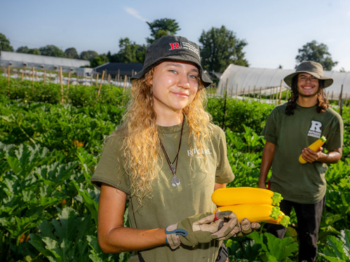 Two students working in a garden.