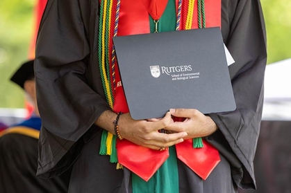 A graduate holding a diploma.